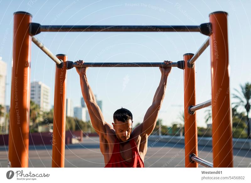 Fit man working out in climbing parcour, doing pull ups mid adult men mid adult man mid-adult men mid-adult man Climbing Parcour fitness chin-ups pull-ups