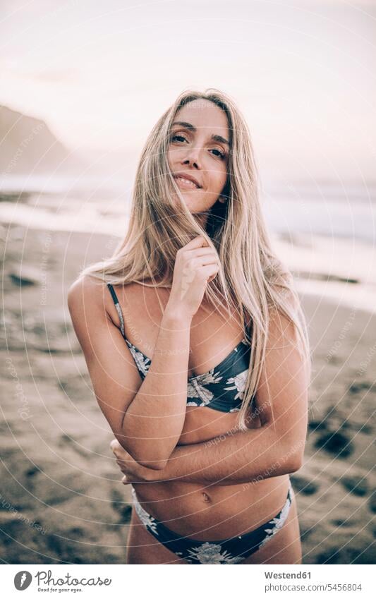 https://www.photocase.com/photos/5456804-young-blond-woman-wearing-bikini-at-the-beach-and-looking-at-camera-photocase-stock-photo-large.jpeg