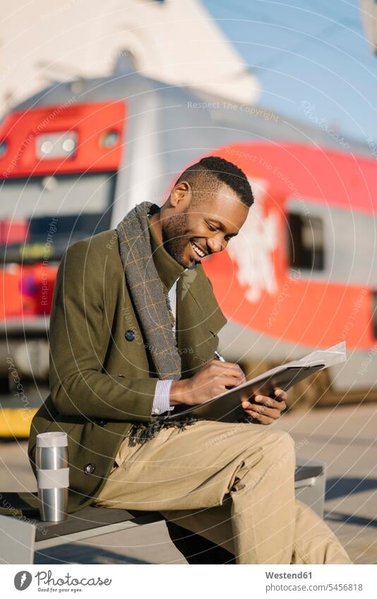 Portrait of stylish businessman with reusable cup and documents waiting for the train Occupation Work job jobs profession professional occupation business life