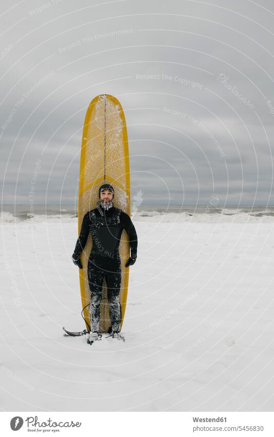 Surfer with surfboard in snow in Ontario, Canada human human being human beings humans person persons caucasian appearance caucasian ethnicity european 1