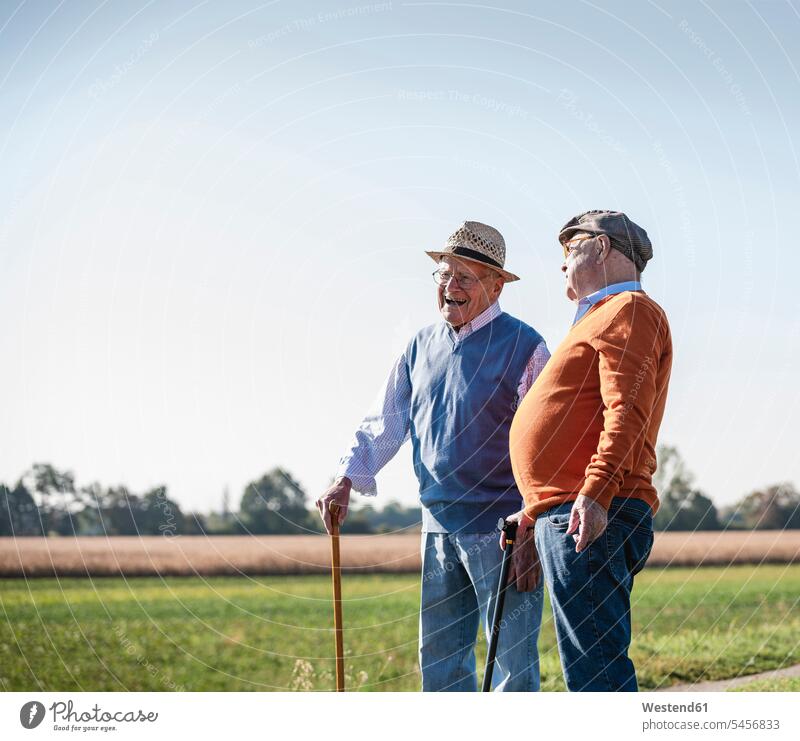 Two old friends standing in the fields, talking about old times walking going Stroll Best Friend Best Friends Best Pal laughing Laughter watching looking