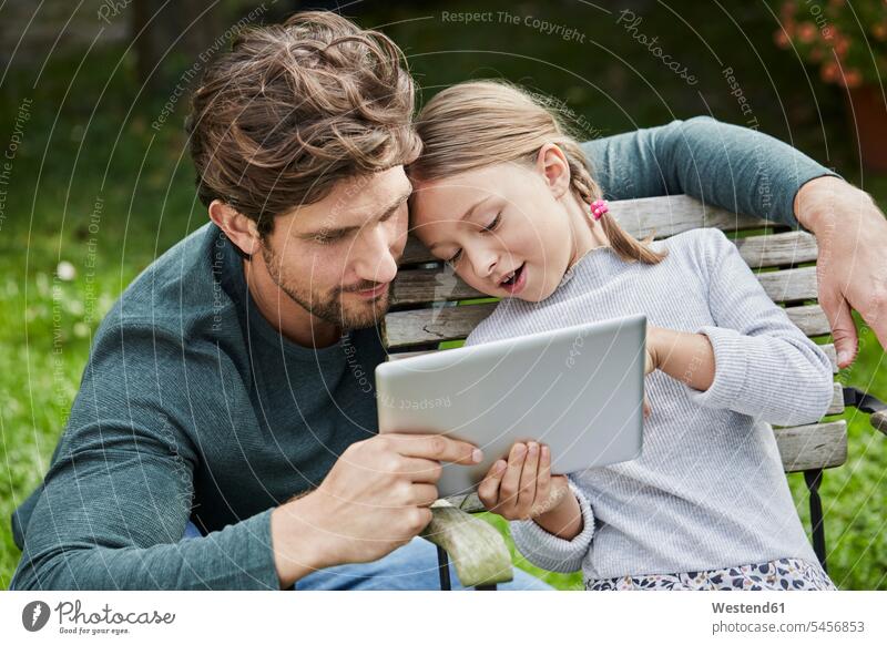 Father and daughter using tablet together in garden father pa fathers daddy dads papa gardens domestic garden digitizer Tablet Computer Tablet PC