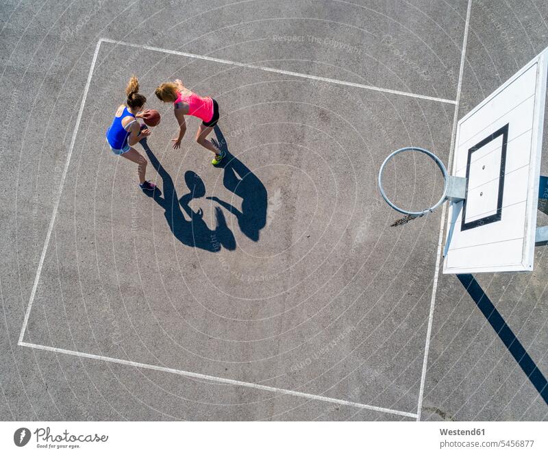 Young women playing basketball, aerial view basketball hoop backboard basketball hoops sport sports Basketball sports field sports fields leisure free time