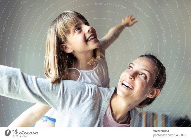 Mother and daughter playing at home, pretending to fly human human being human beings humans person persons caucasian appearance caucasian ethnicity european