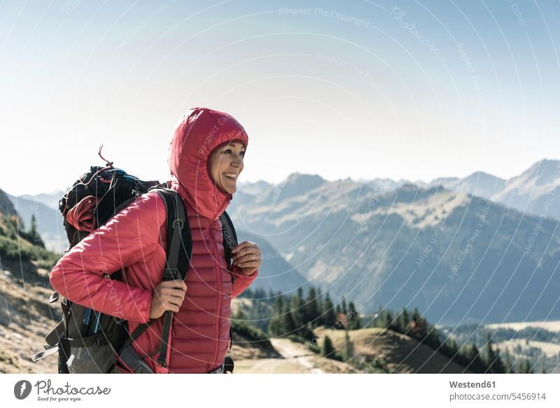 Austria, Tyrol, smiling woman on a hiking trip in the mountains enjoying the view females women mountain range mountain ranges happiness happy indulgence