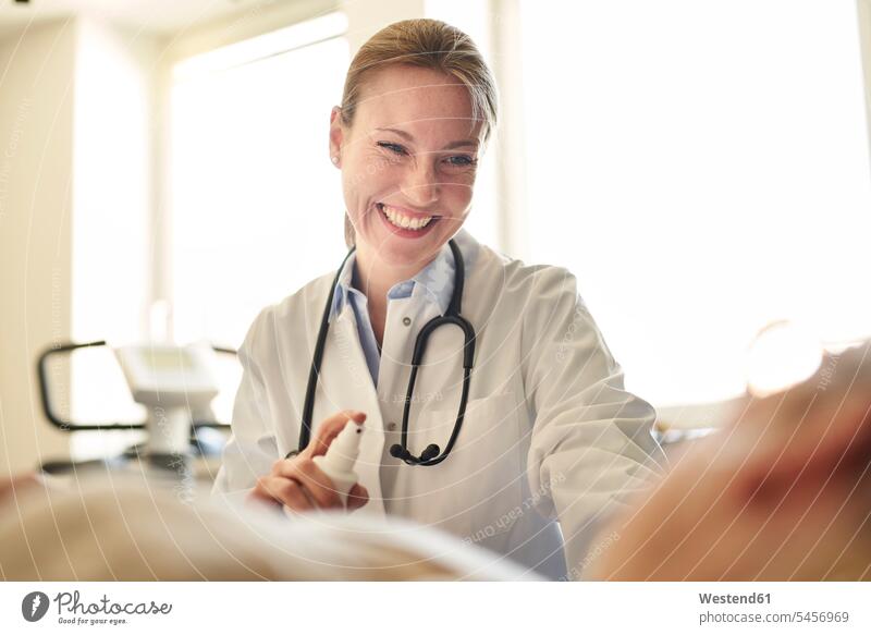 Smiling female doctor preparing a blood sampling from patient in medical practice Preparation prepare physicians doctors examination examine examinations