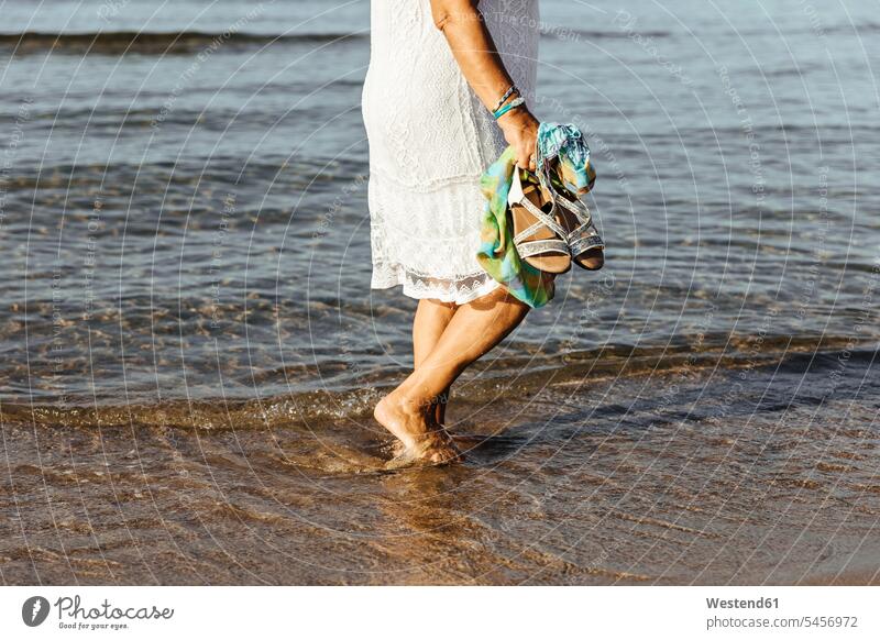 Close-up of senior woman wading in the sea, El Roc de Sant Gaieta, Spain human human being human beings humans person persons caucasian appearance