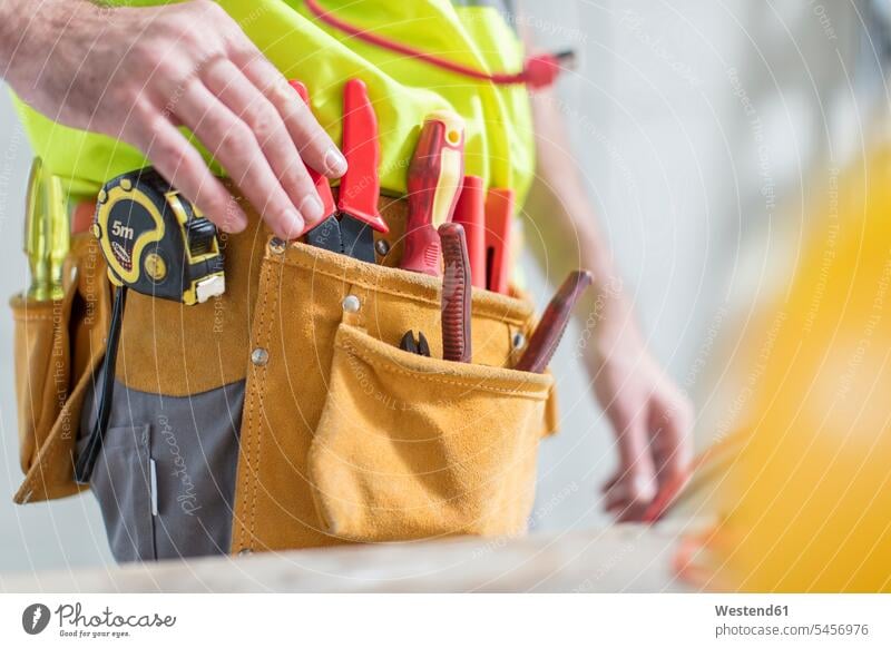 Close-up of construction worker with tool belt tools Tool Kit builders working At Work device devices craftsman trade craftsmen Craft Occupation Manual Workers
