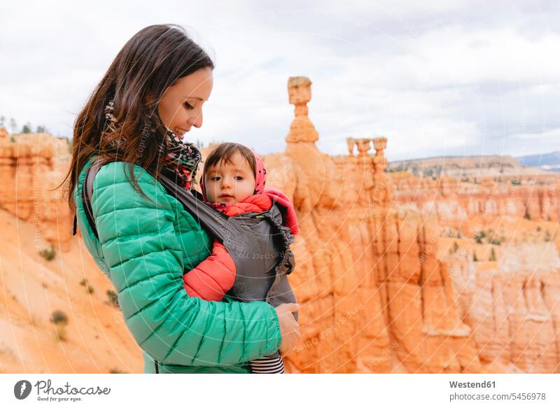 Woman carrying her daughter in a baby carrier at hoodoos in Bryce Canyon, Utah, USA day daylight Nature rural scene series elevated view view from above