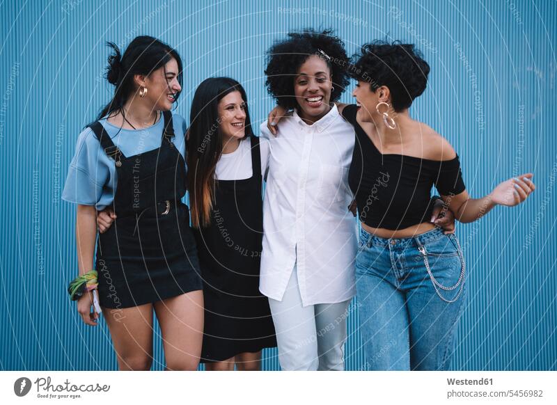 Laughing women in front of a blue wall human human being human beings humans person persons Middle Eastern caucasian appearance caucasian ethnicity european