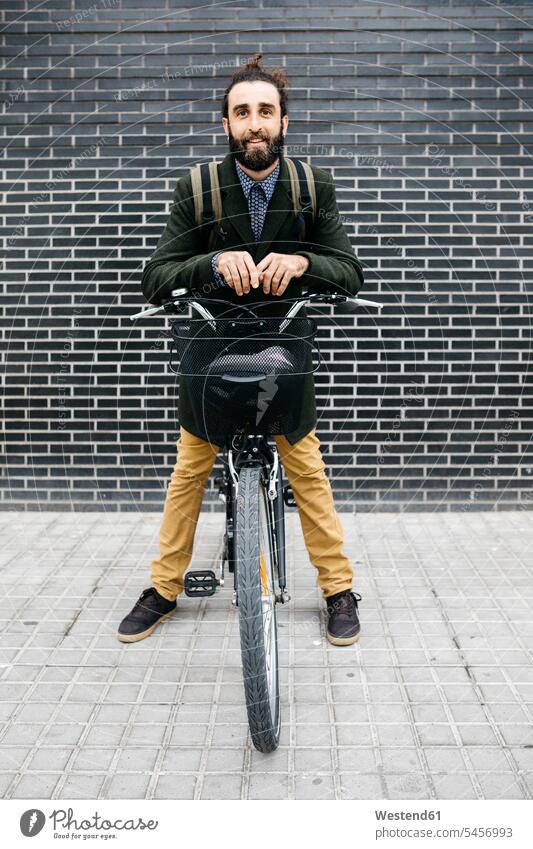 Portrait of smiling man with e-bike at a brick wall portrait portraits bicycle bikes bicycles smile E-Bike Electric bicycle Electric Bike brick walls men males