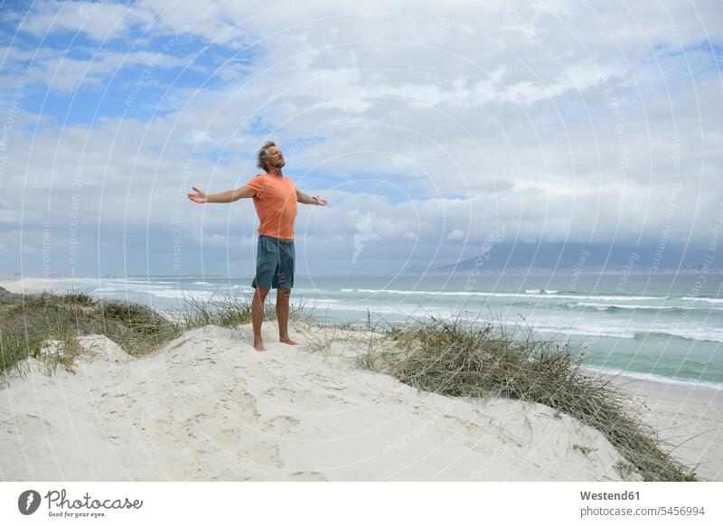 South Africa, man raising arms at Bloubergstrand alone solitary solo nature experience love of nature men males Freedom Liberty free Inspiration intuitional