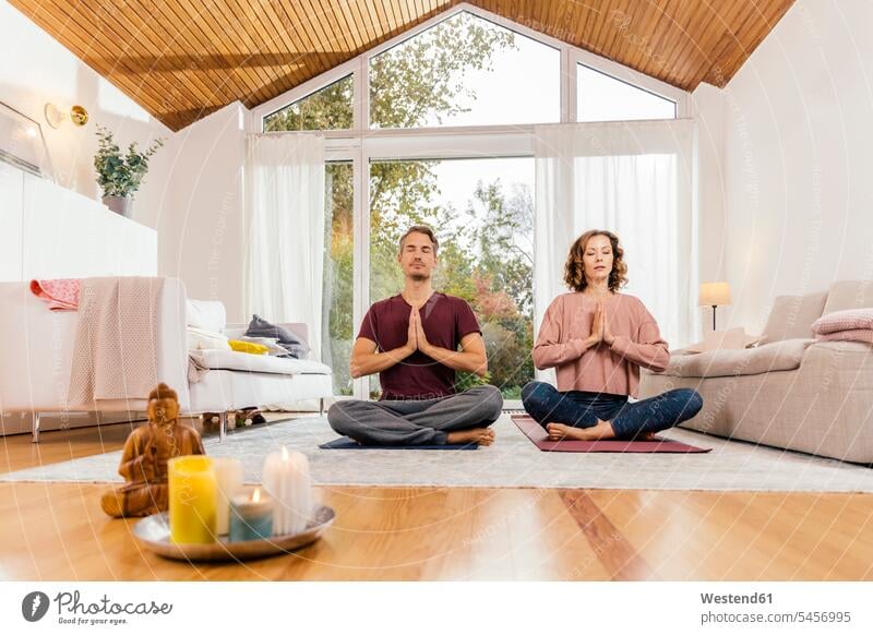 Couple meditating together at home human human being human beings humans person persons caucasian appearance caucasian ethnicity european 2 2 people 2 persons