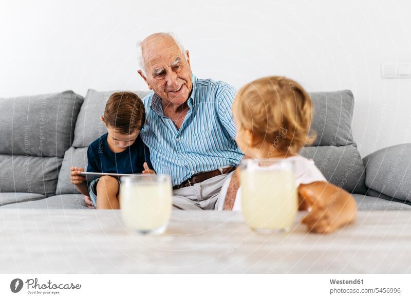 Portrait of grandfather spending time with his grandson and granddaughter portrait portraits grandsons granddaughters grandpas granddads grandfathers grandchild