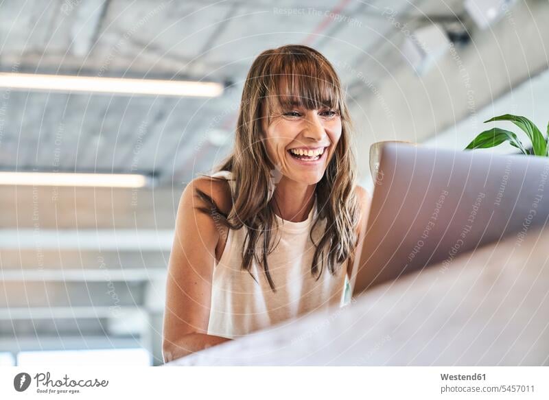Woman smiling while using laptop at home color image colour image indoors indoor shot indoor shots interior interior view Interiors day daylight shot