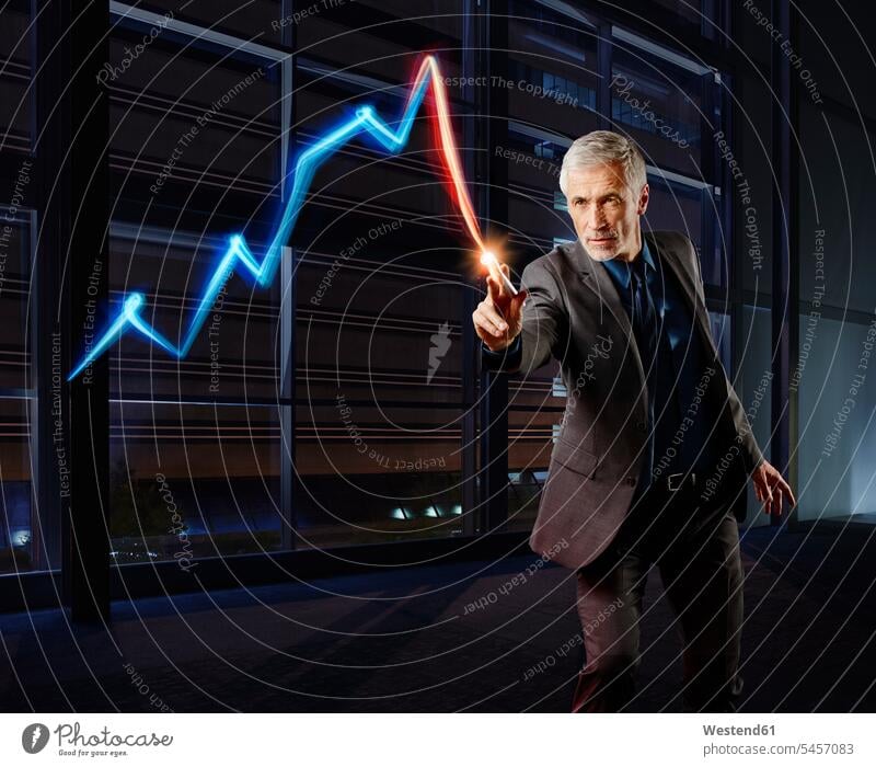 Businessman painting the stock market development with light Business man Businessmen Business men broker trader stocks and shares financial market