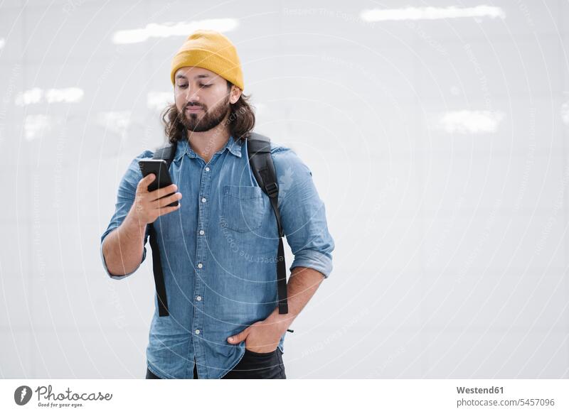 Portrait of man with backpack looking at smartphone human human being human beings humans person persons Middle Eastern 1 one person only only one person adult