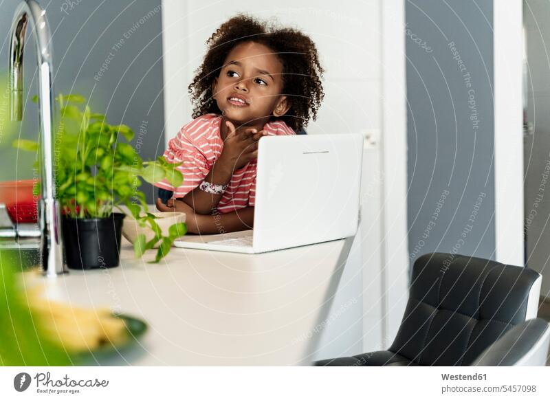 Girl with laptop in kitchen human human being human beings humans person persons Mixed Race mixed race ethnicity mixed-race Person 1 one person only