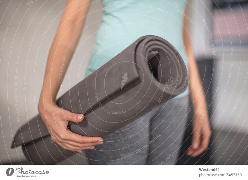 Close-up of woman carrying yoga mat in studio studios females women Yoga Mat Adults grown-ups grownups adult people persons human being humans human beings mats