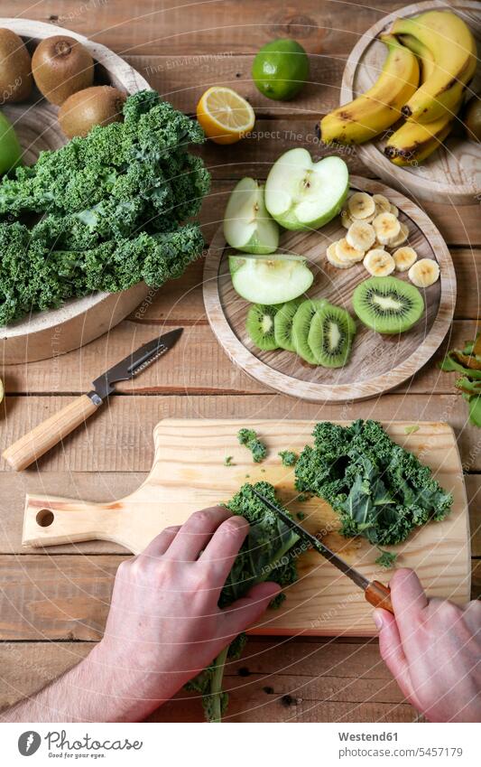 Man preparing green smoothie cutting kale preparation prepare ingredient ingredients Kitchen Knife Kitchen Knives ginger root ginger roots rich in vitamines