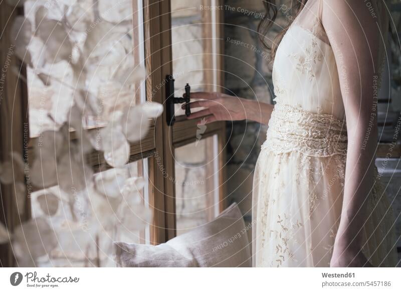 Young woman in elegant wedding dress opening window indoor interior shot indoors interiour photo interiour photos interiour shots Contemporary cutout cutouts
