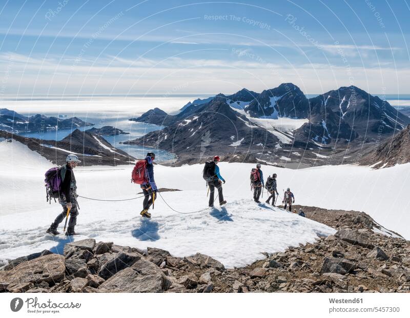 Greenland, Sermersooq, Kulusuk, Schweizerland Alps, group of people walking in snow Group groups of people going persons human being humans human beings