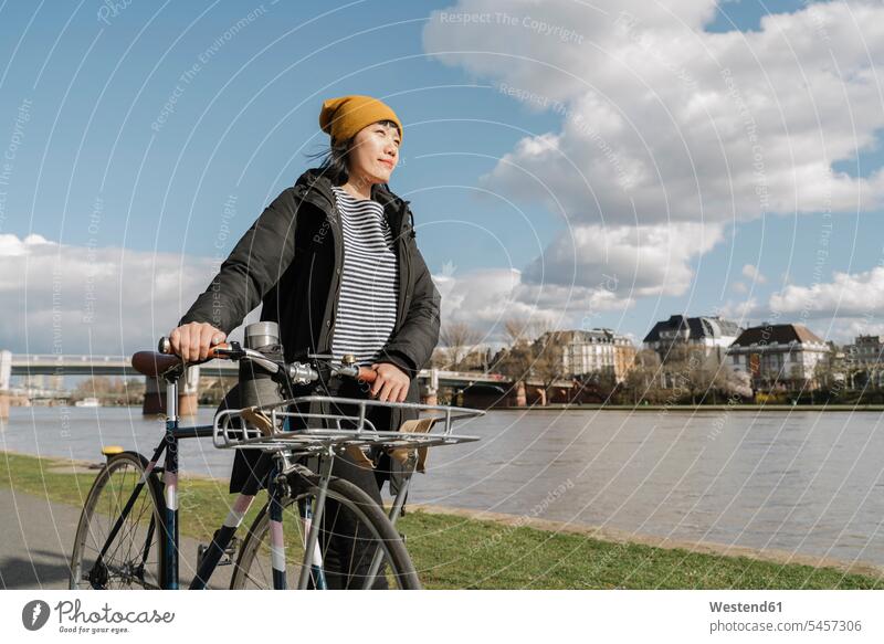 Woman with bicycle on the riverbank, Frankfurt, Germany transport bikes bicycles bike - bicycle Cycle Cycle - Vehicle go going walk smile travel traveling