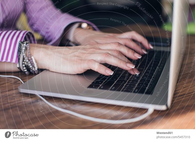 Hands of businesswoman using laptop on desk in office color image colour image indoors indoor shot indoor shots interior interior view Interiors business people