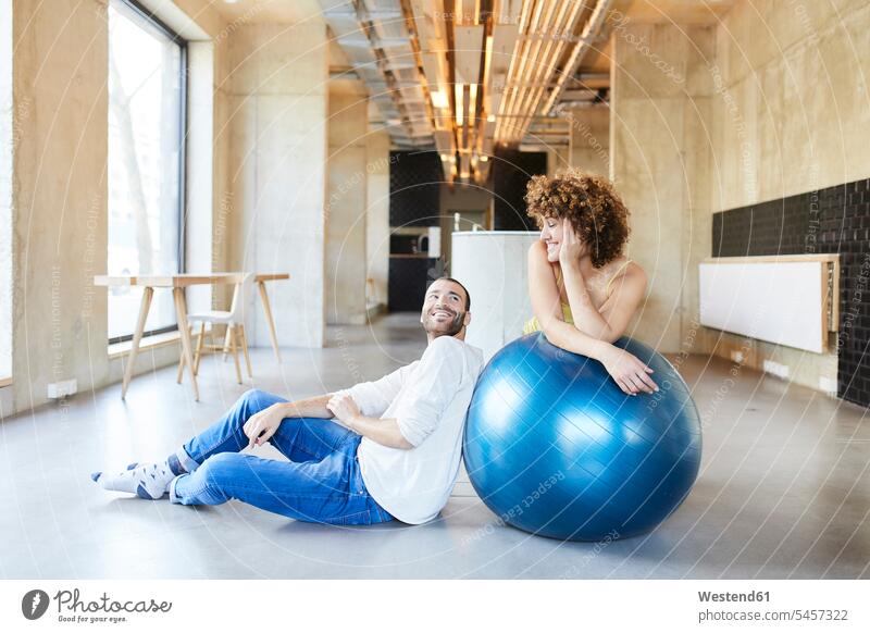 Smiling man and woman with fitness ball in modern office Germany mindfulness aware awareness self-care Fitness Ball Fitness Balls Balance Ball exercise ball