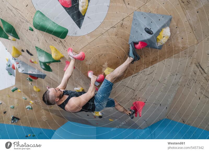 Man bouldering in climbing gym (value=0) human human being human beings humans person persons caucasian appearance caucasian ethnicity european 1