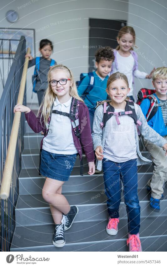Happy pupils on staircase leaving school schools leave staircases stairwell student happiness happy schoolchildren education leisure free time leisure time