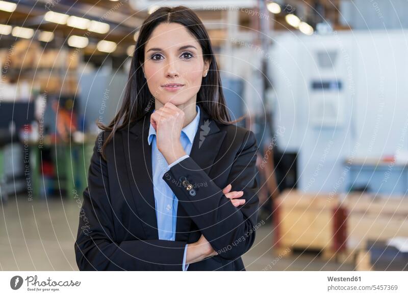 Portrait of confident businesswoman in a factory portrait portraits businesswomen business woman business women modern contemporary confidence factories