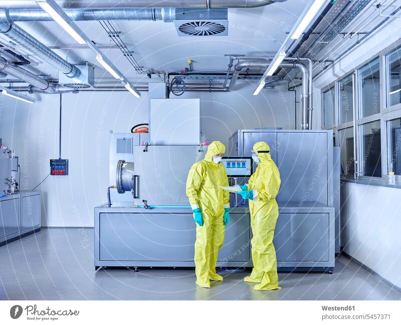 Chemists working in industrial laboratory, wearing protective clothing in the clean room Chemical Laboratory chemist Protective Suit At Work natural scientist