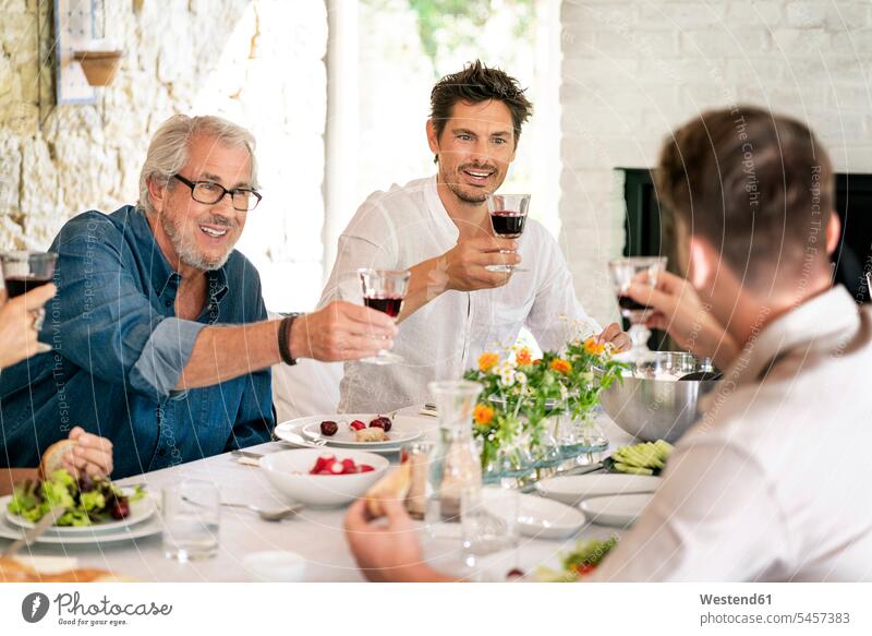 Happy family having meal together clinking wine glasses Meals happiness happy Wine Glass Wine Glasses Wineglass Wineglasses toasting cheers families Food foods