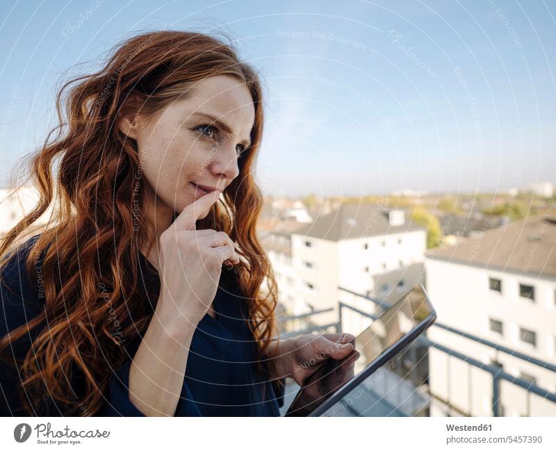 Redheaded woman with tablet on rooftop terrace human human being human beings humans person persons caucasian appearance caucasian ethnicity european 1