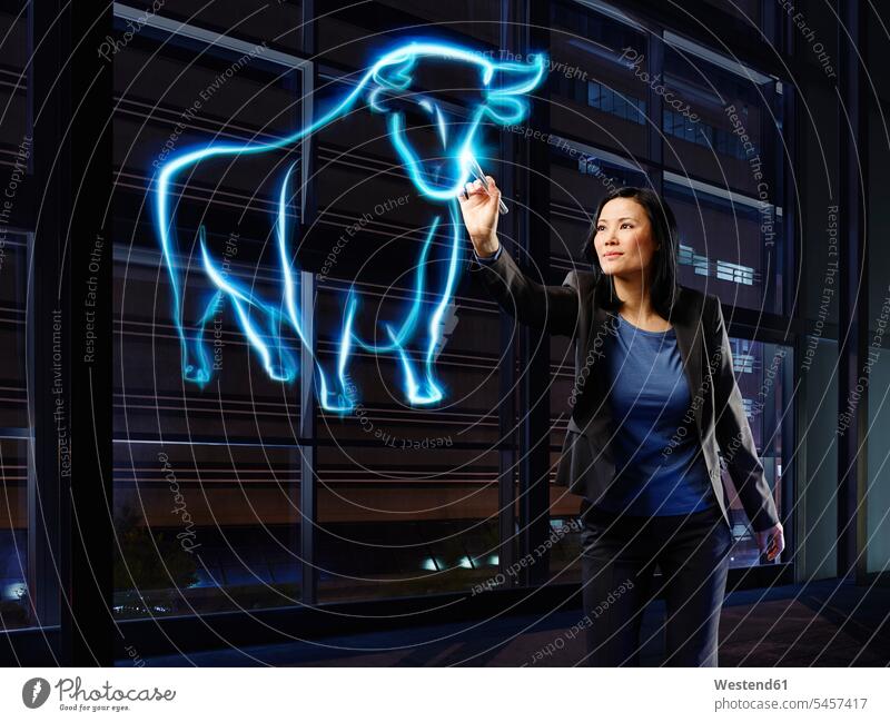 Businesswoman painting a bull with light businesswoman businesswomen business woman business women stock market stocks and shares financial market