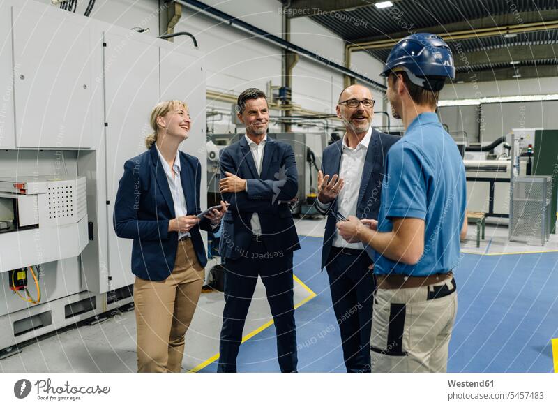 Business people and worker talking in a factory human human being human beings humans person persons caucasian appearance caucasian ethnicity european Group