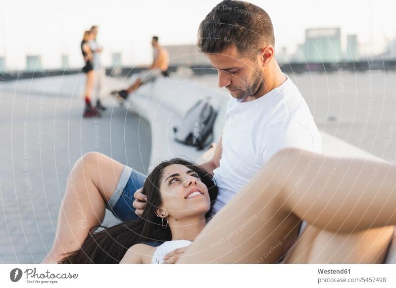 Happy young woman lying on lap of her boyfriend, portrait laying down lie lying down Boyfriends happiness happy Love loving couple twosomes partnership couples