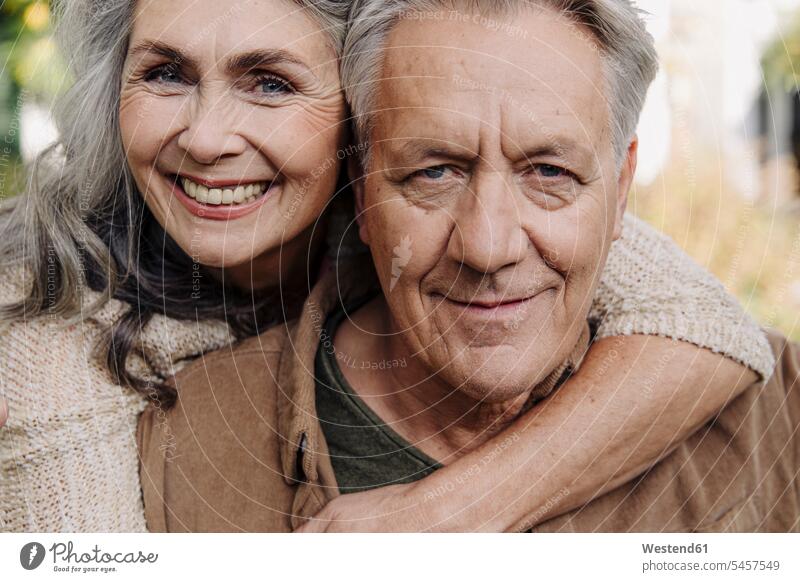 Portrait of a happy senior couple outdoors heads faces human face human faces relax relaxing smile embrace Embracement hug hugging seasons fall relaxation