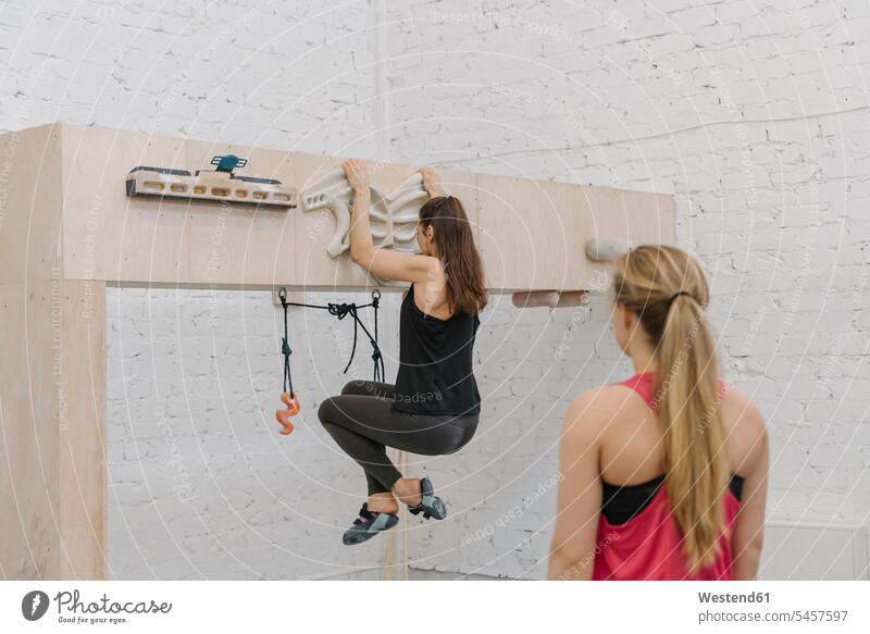 Woman doing pull-ups before climbing (value=0) friends mate female friend exercise practising train training hold exercising practice practise free time