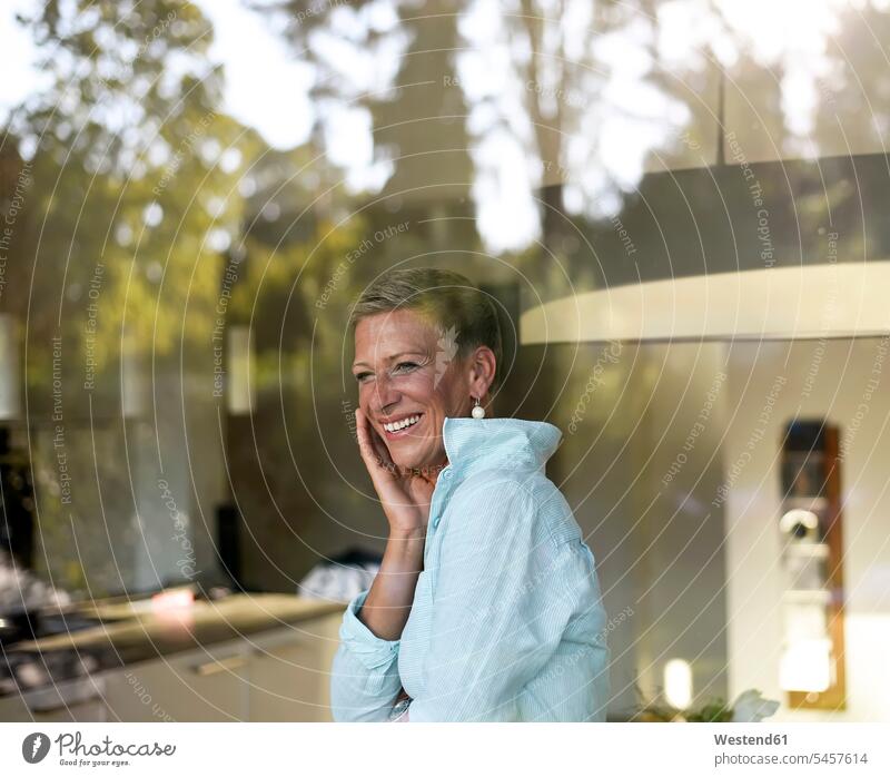 Portrait of laughing woman looking out of window portrait portraits windows females women view seeing viewing Laughter Adults grown-ups grownups adult people