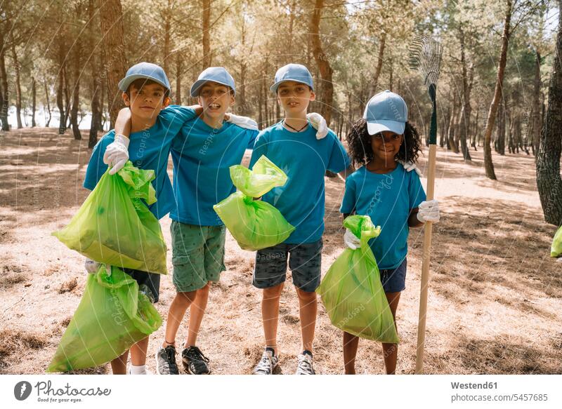 Group portrait of volunteering children collecting garbage in a park forests wood woods collected responsible projects T- Shirt t-shirts tee-shirt hygienic