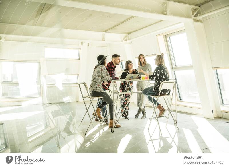 Group of creative professionals having a meeting in a bright office, discussing new solutions offices office room office rooms Creative People creatives