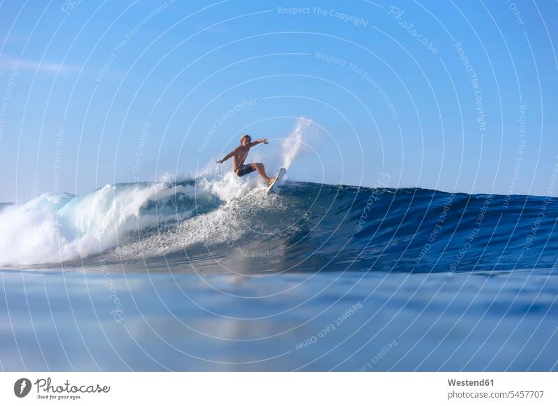 Indonesia, Sumatra, surfer on a wave surfing surf ride surf riding Surfboarding man men males surfboard surfboards surfers Sea ocean waves water sports