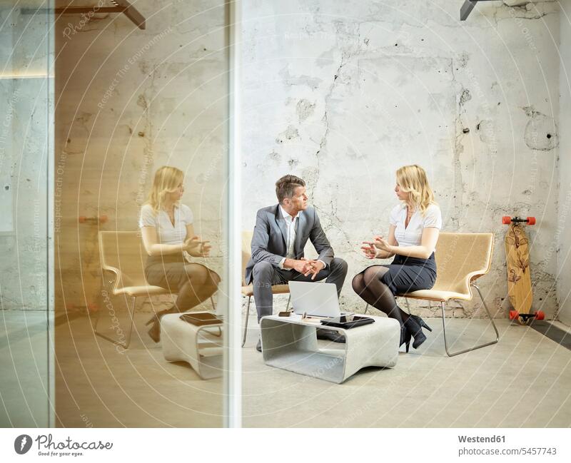 Businessman and businesswoman talking in modern office businesswomen business woman business women Business man Businessmen Business men speaking contemporary