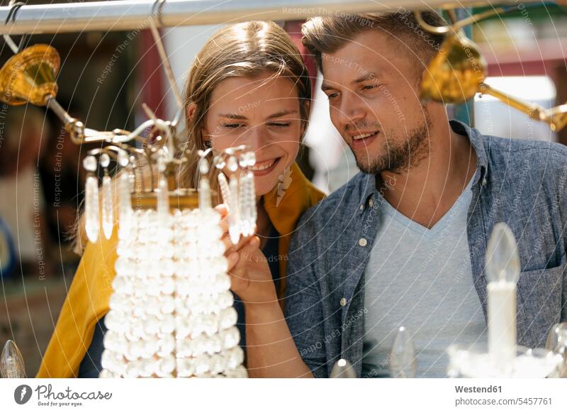 Belgium, Tongeren, happy young couple on an antique flea market twosomes partnership couples antiques happiness people persons human being humans human beings