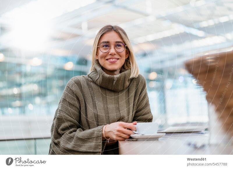 Portrait of a smiling young woman in a cafe Tables Eye Glasses Eyeglasses specs spectacles smile travel traveling drink relax relaxing relaxation delight