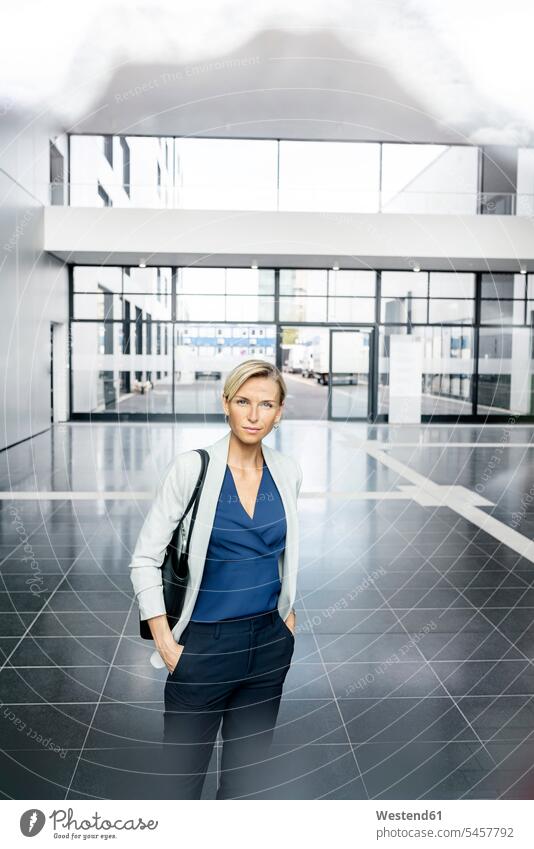 Successful businesswoman standing in entrance hall of office building, lokking at camera Occupation Work job jobs profession professional occupation