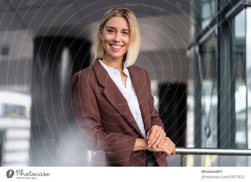 Portrait of confident young businesswoman leaning on railing human human being human beings humans person persons caucasian appearance caucasian ethnicity