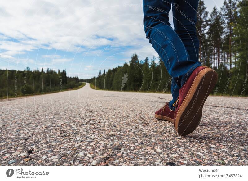 Finland, Lapland, feet of man walking on empty country road emptiness men males rural road rural roads country roads foot human foot human feet going Adults